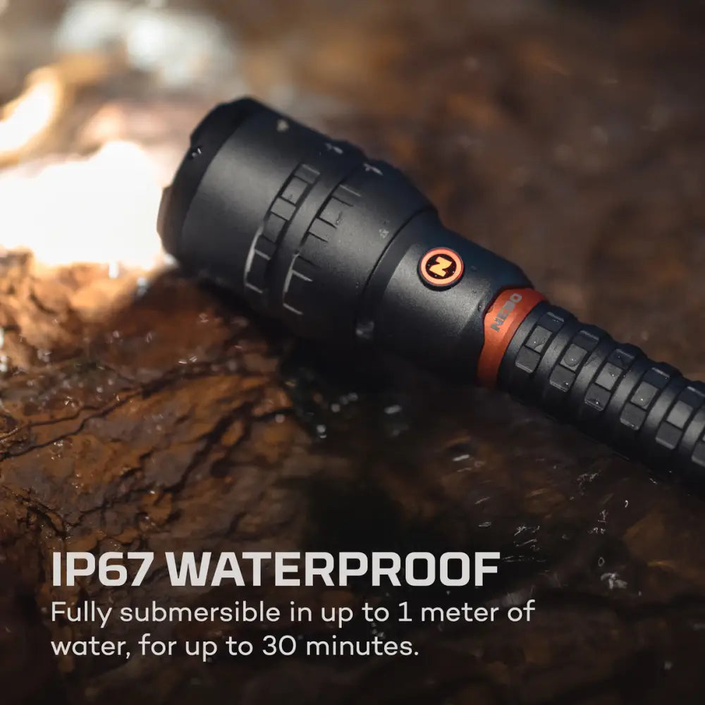 Black tactical flashlight 12k with orange accent ring and textured grip designed for rugged outdoor use