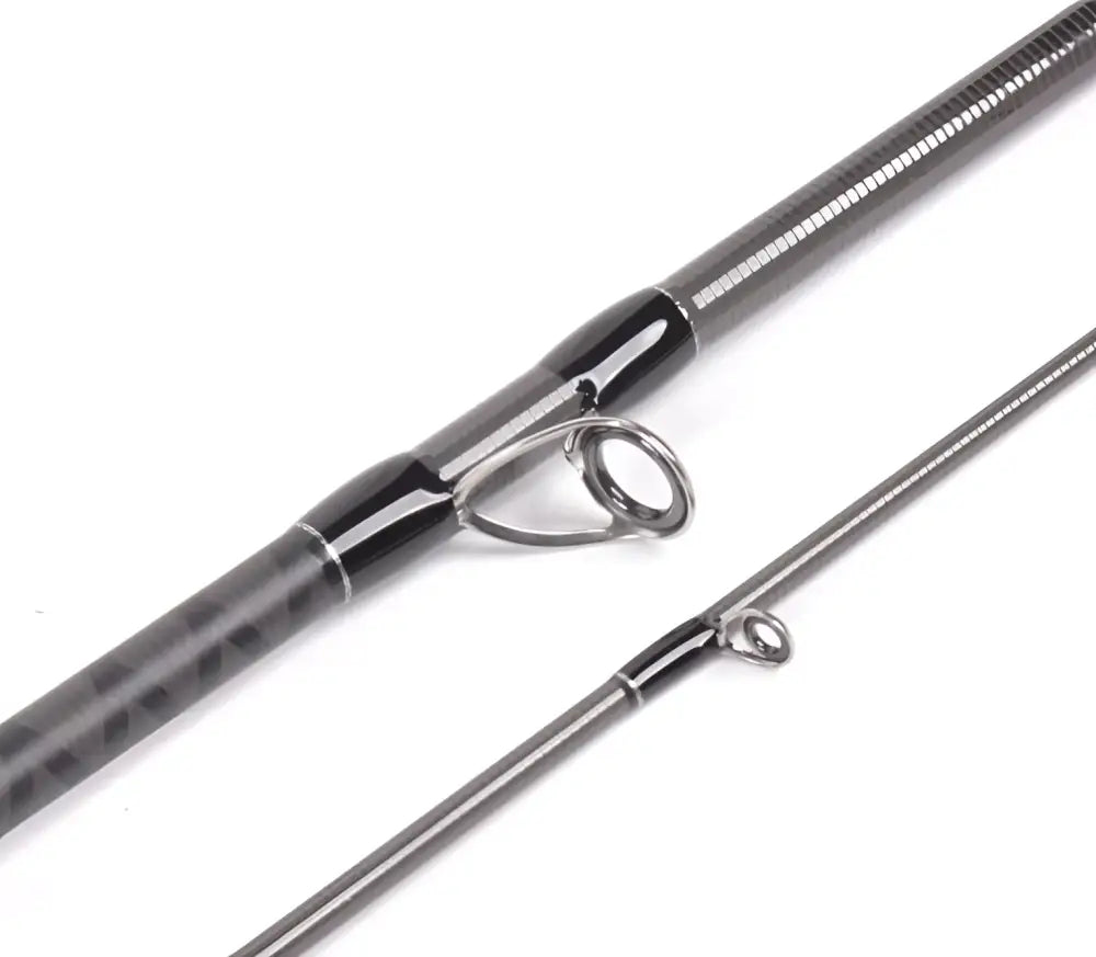 A sleek dark gray carbon fiber Blacksox Bsx 742MH hyrräkelavapa with black grip and metallic silver reel seat
