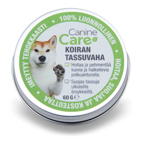 Pyöreä hopeinen metallitinssi jossa on 60g caninecare tassuvaha koiran tassuvoide vihreällä ja valkoisella etiketillä shiba inu kuvalla