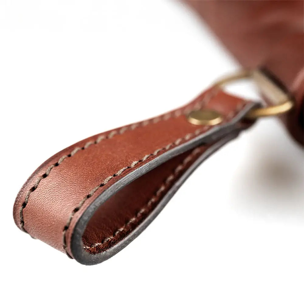 Kirvesmiehenveitsi keychain in brown leather with contrasting dark stitching and brass-colored metal clasp for uhc use