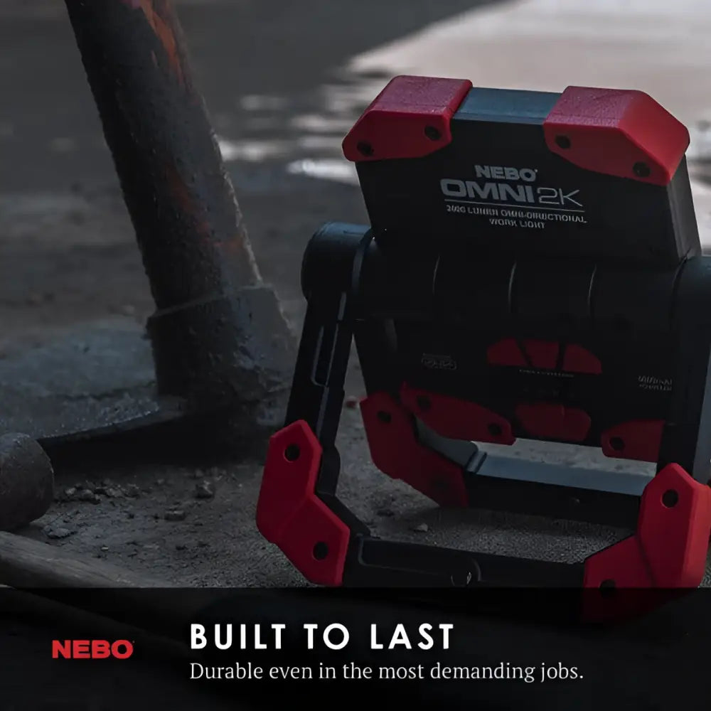 Red and black nebo omni 2k worklight with rugged industrial design for heavy-duty illumination tasks