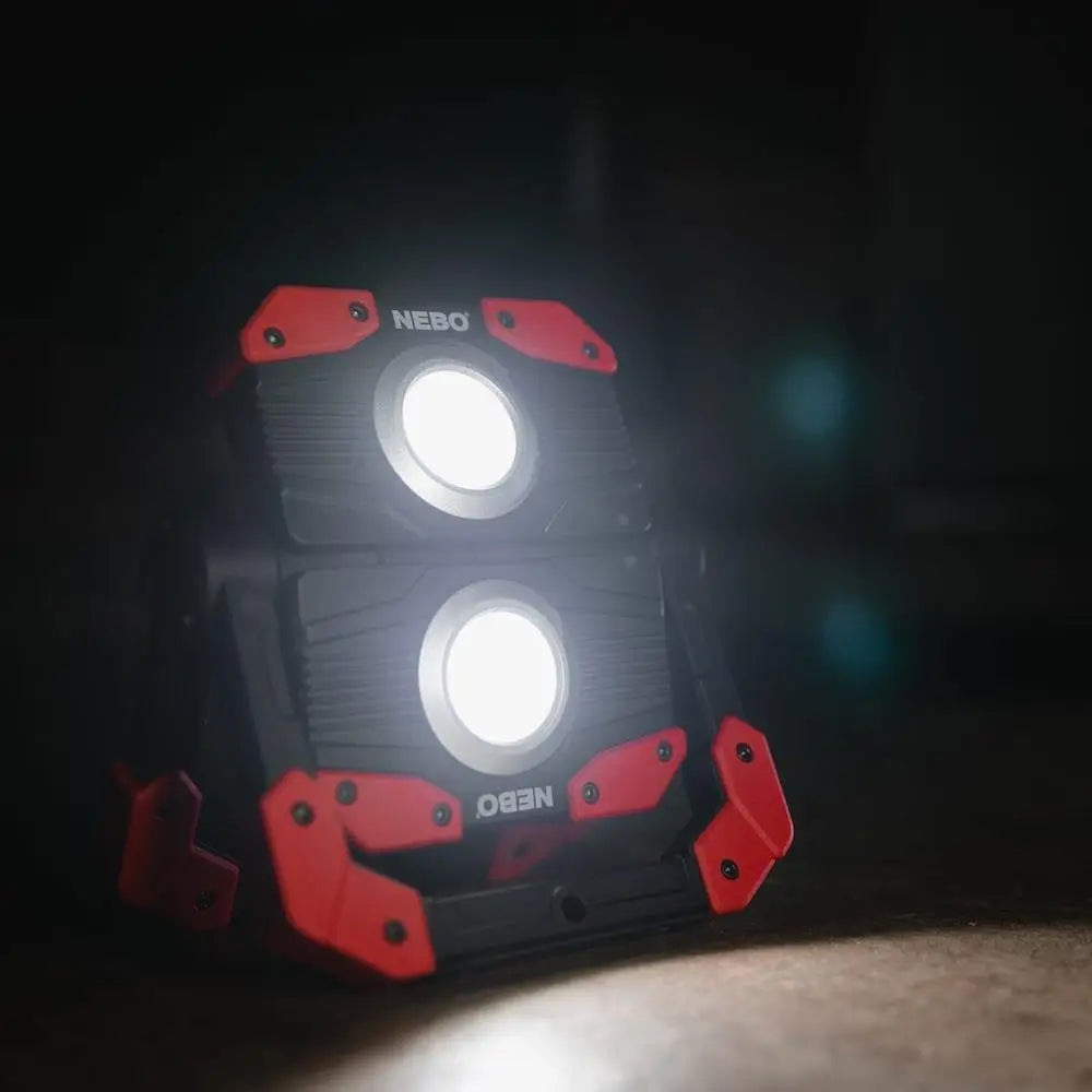 Red and black Nebo OMNI 2K Worklight dual-head work light with bright circular bulbs for heavy-duty use
