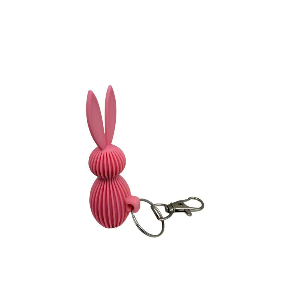 Pupu avaimenperä pinkki silikonipupu ribbikuvioidulla pinnalla ja metallikiinnityksellä