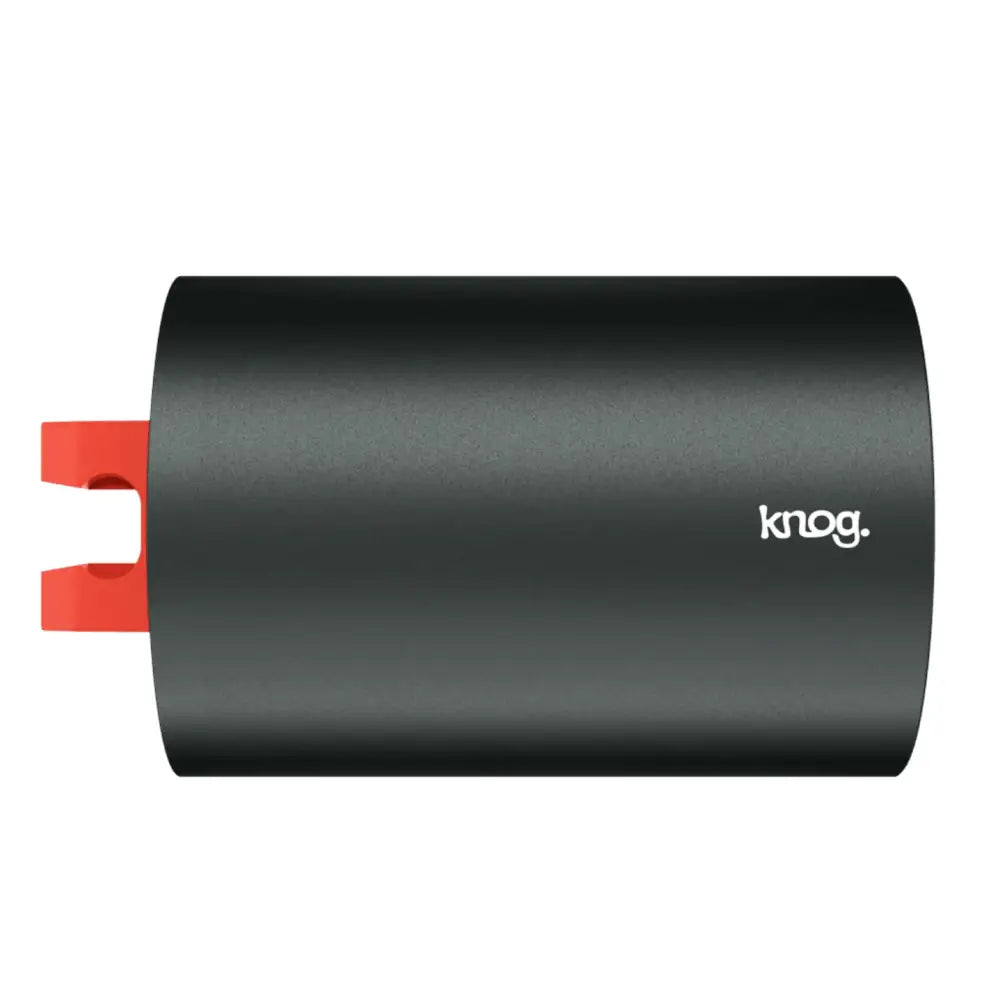 Black cylindrical knog pwr flashlight lighthead 600l battery with red clip on one end visible