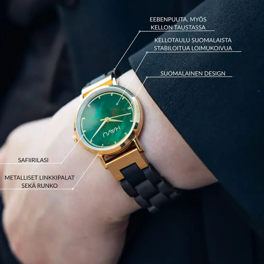 Gold-toned revontuli eebenpuu 32mm watch with vibrant green dial black silicone strap and havu branding