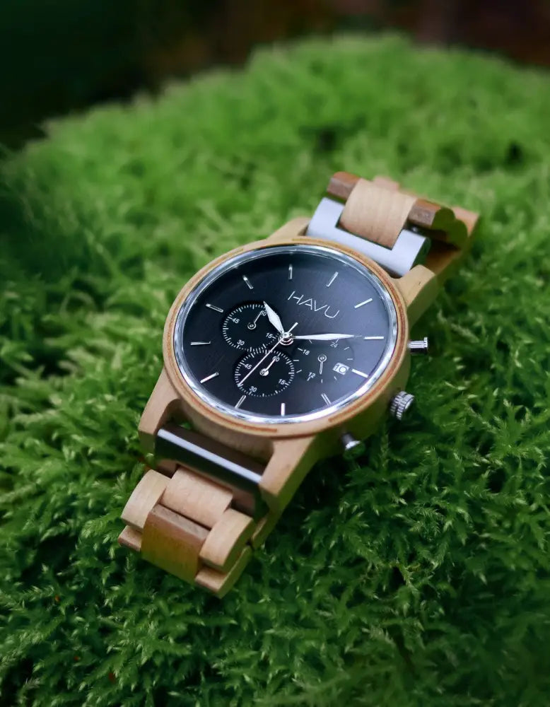A natural-toned wooden havu kronografi watch with a black dial and silver-tone accents made from Finnish wood