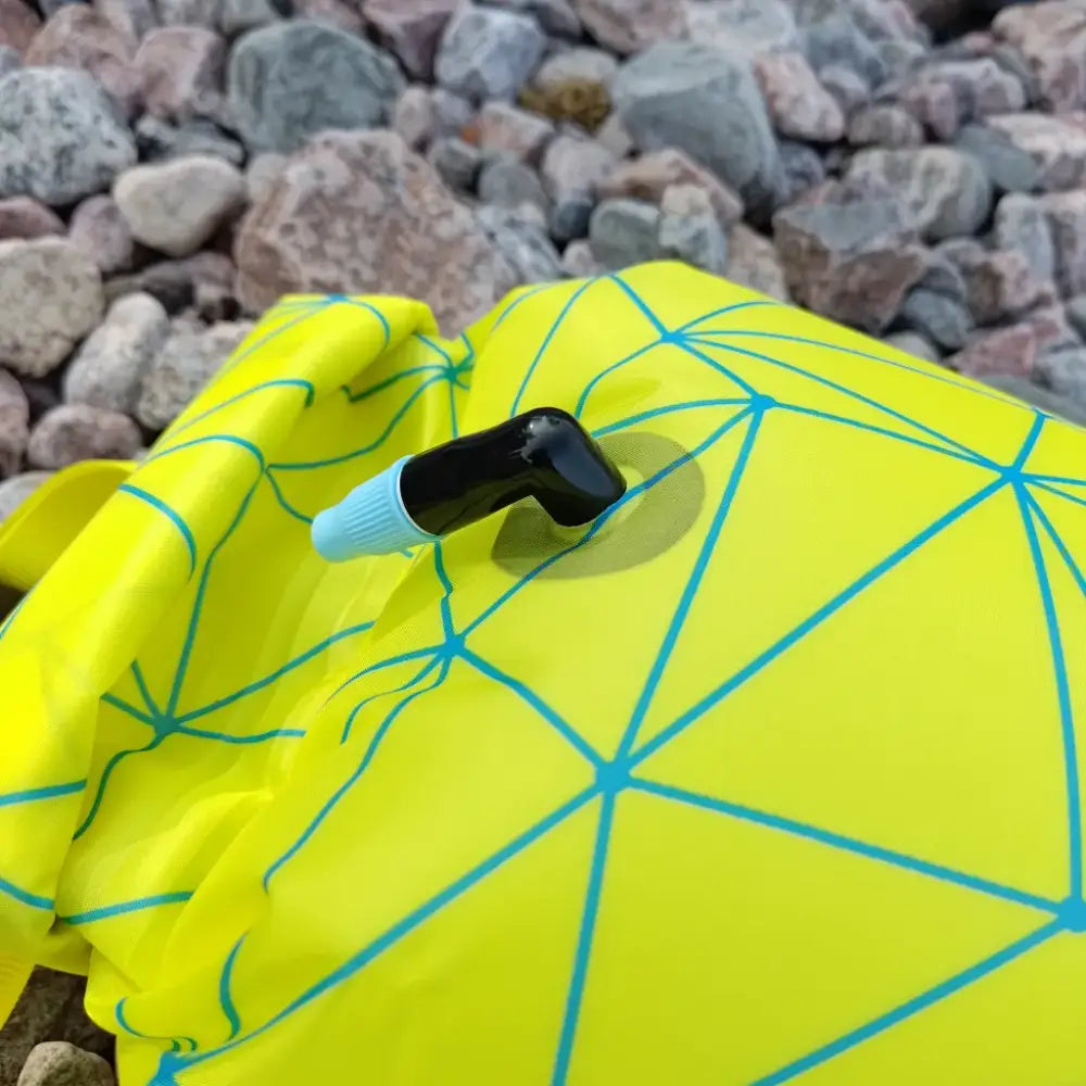 Bright yellow ultra dazzle drybag buoy inflatable tent with geometric blue pattern and black and light blue valve